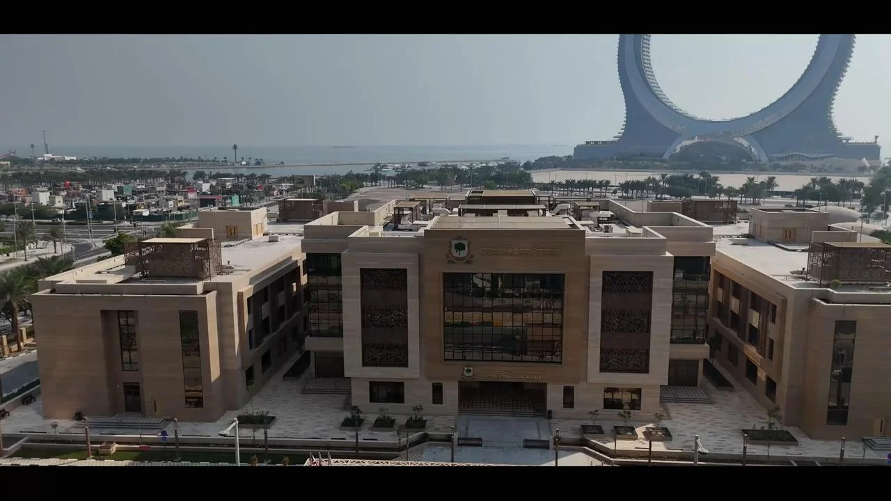 Modern architectural exterior of the Newton Schools campus in Doha, Qatar.