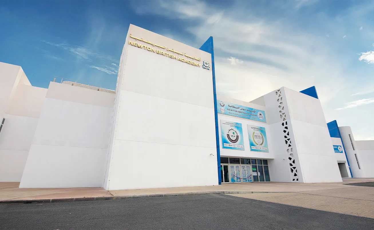 The modern exterior and entrance of Newton British Academy (NBA) located in Barwa City, Doha, Qatar.