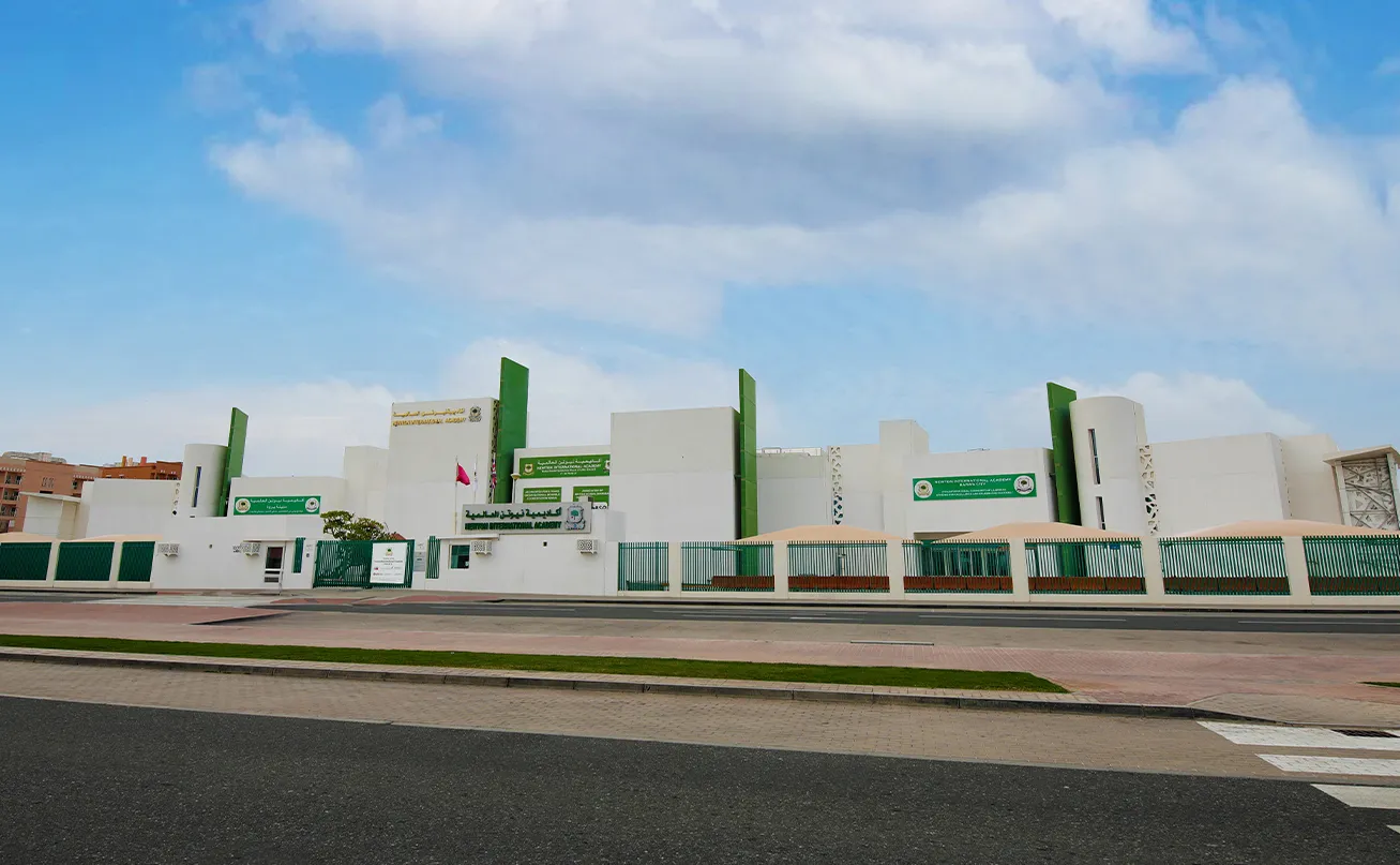 View of the Newton International Academy (NIA) campus building and surrounding grounds in Barwa City.